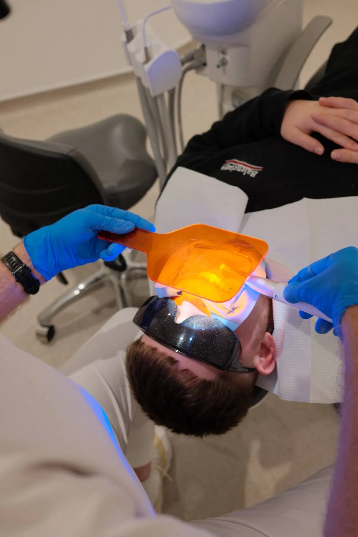 Composite being light cured during a bonding appointment at Crossbank